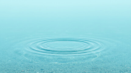 Fototapeta premium Circular ripple wave on the surface of calm blue water
