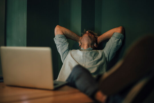 Tired man sitting in office, working late in his start-up company