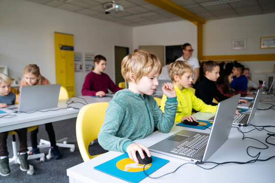 Students learning coding in computer classroom