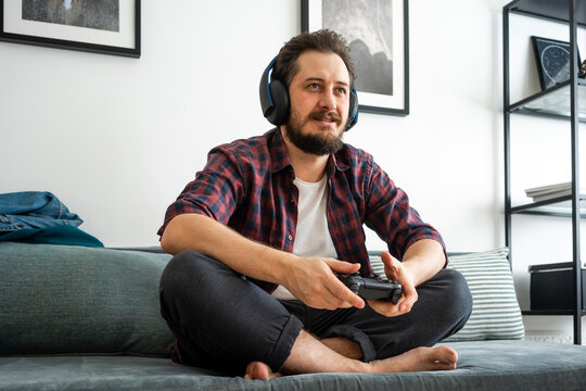 Man sitting on couch and playing video game