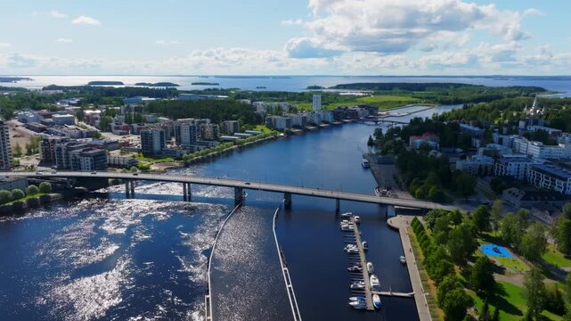 Establishing drone shot of traffic on the Suvantosilta, sunny day in Joensuu