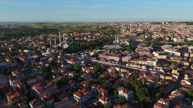 aerial drone tracking shot over the historic city of Edirne, Turkey. Cinematic viewpoint showcasing dense urban neighborhoods and cultural architectural heritage at daylight