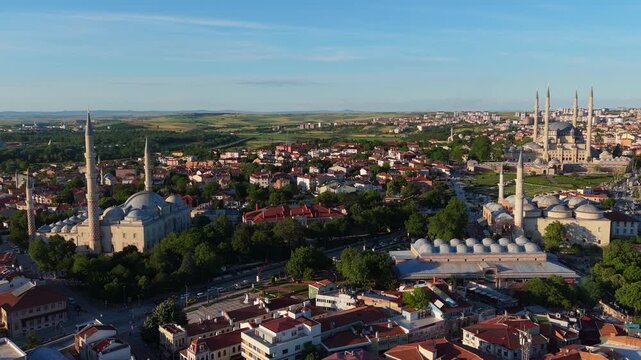 Scenic wide drone shot approaching the historic Selimiye Mosque and the sprawling urban landscape of Edirne city under a clear sky, Turkey