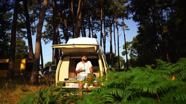 Man Relaxing in Open Vintage Campervan in Pine Forest &ndash; Van Life Lifestyle
