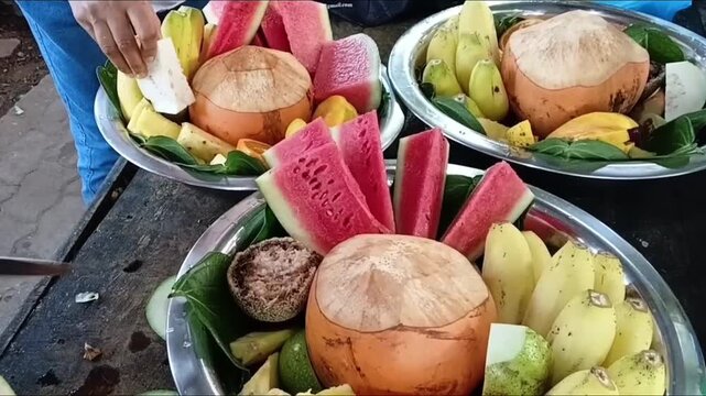Placing Fresh Sliced Guava on a Silver Platter to Assemble a Traditional Sri Lankan Palathuru Wattiya Offering for Temple Deity Worship