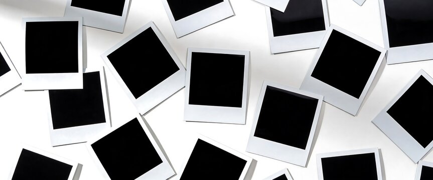 Collection of blank instant photo frames scattered on white background for mockup