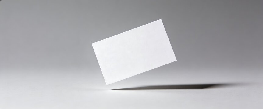 Minimalist blank white business card template mockup with elegant shadow on gray