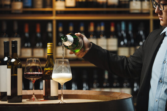 Sommelier Pouring Sparkling Wine in Cellar