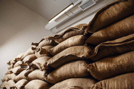 Large Warehouse Filled to Ceiling With Burlap Coffee Bags From Various Countries Awaiting Distribution