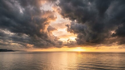 Fototapeta premium Storm clouds dramatically part over calm golden-hour seascape, brilliant sunset light breaks through dark formations, serene water reflects warm ethereal glow, moody atmospheric coastal view