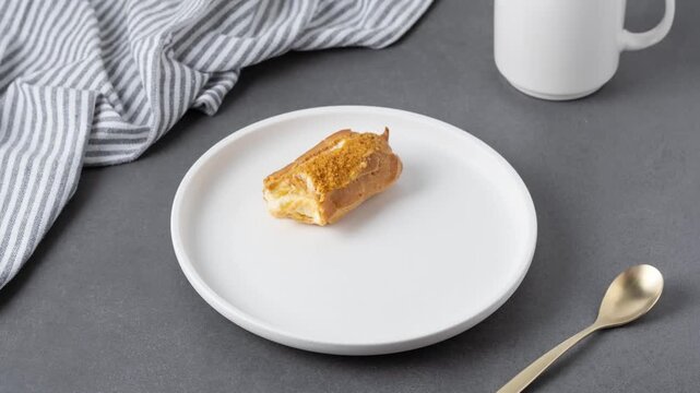 Delicious eclair on a white plate