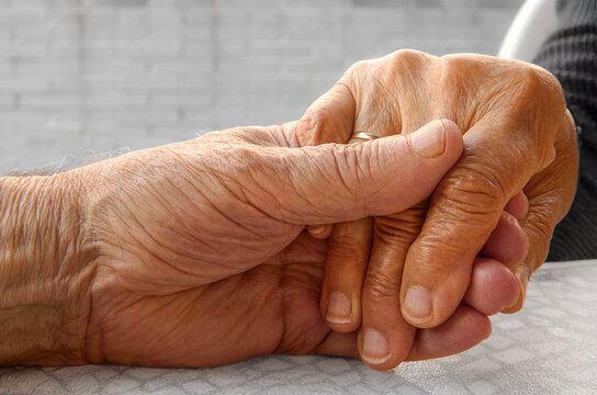 Senior couple holding hands