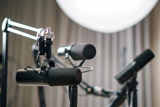 Broadcast dynamic microphones suspension arms recording studio background soft light