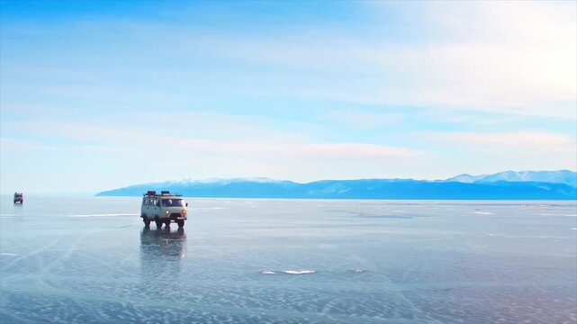 Vintage Russian van driving on the frozen surface of a large lake during a winter expedition