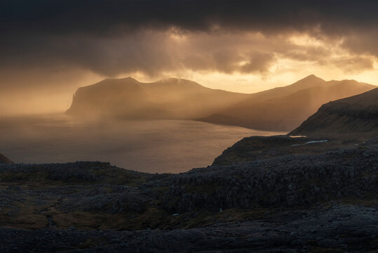 Misty fjord with Vagar silhouetted in the distance, Sornfelli viewpoint, Streymoy, Faroe Islands.