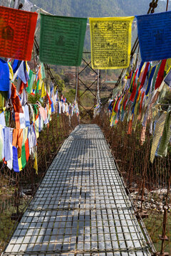 Prayer flags decorating footbridge in Punakha Valley, Punakha, Bhutan