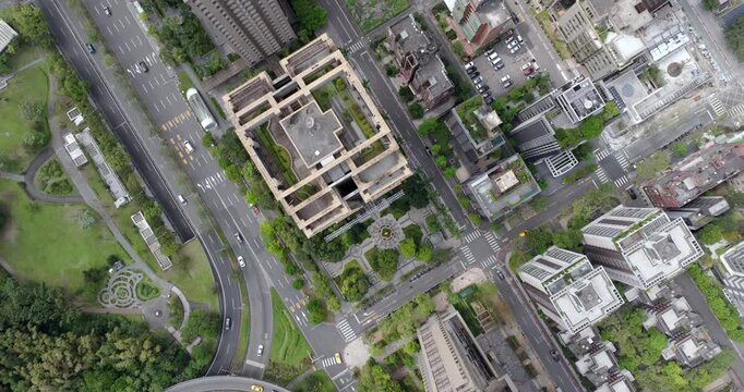 Top down aerial view of Taipei, the vibrant capital city of Taiwan, showing streets and high-rise buildings in the Xinyi District on a sunny day.