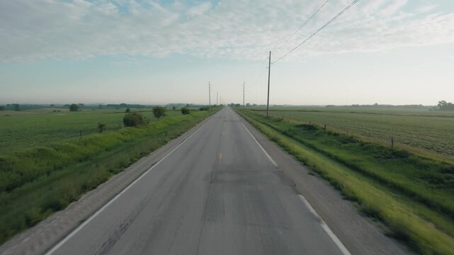 Fast drone shot of a road in rural Iowa