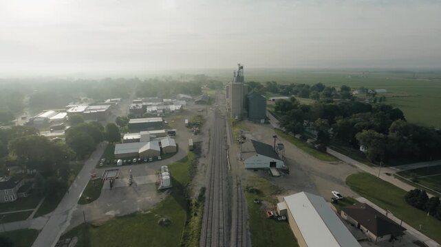 Aerial shot of a railroad going into rural Iowa town