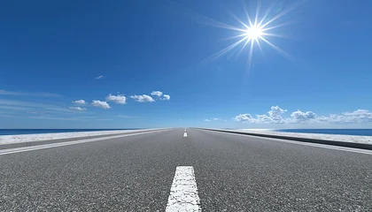 Endless asphalt highway stretching to the horizon under a bright, sunny sky with ocean on both sides © Generative AI