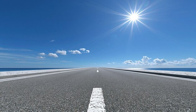 Endless asphalt highway stretching to the horizon under a bright, sunny sky with ocean on both sides