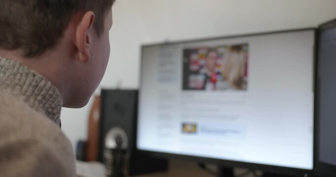 Kid Boy Use Desktop Computer for Study Typing and Reading. 4K 10-bit