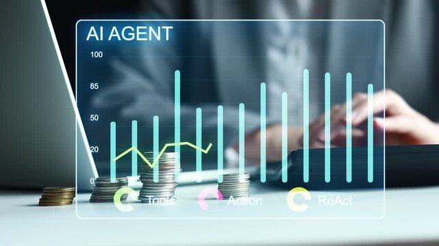 AI agent shows data trends on screen with coins stacked nearby while a person works at a laptop.