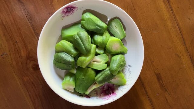 4K Top View Video of Steamed Chayote Sechium Edule Slices on Ceramic Plate for Healthy Cooking and Food Documentary Footage