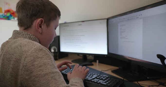 Kid Boy Use Desktop Computer for Study Typing and Reading. 4K 10-bit