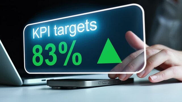 KPI targets at 83 percent with upward trend displayed on a screen at a work desk during daytime hours.