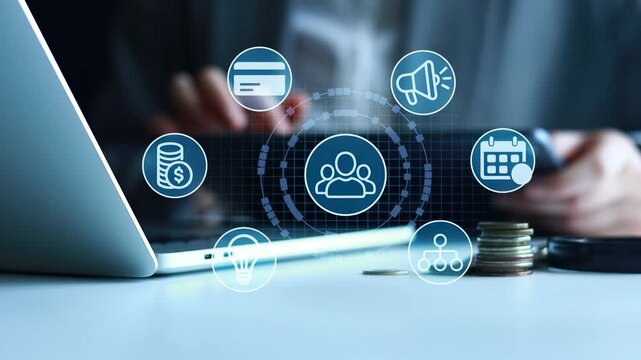 A person is working on a laptop surrounded by symbols of digital marketing. Icons show payment methods, social media, and scheduling. This takes place in an office setting during working hours.