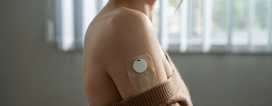 diabetes sensor patch worn on a woman's arm for daily blood sugar measurement and health care.