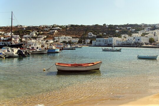 Traditional wooden fishing boat moored in a tranquil harbor, Myk