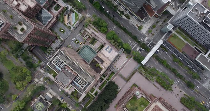 Top down aerial view of Taipei, the vibrant capital city of Taiwan, showing streets and modern skyscrapers in the Xinyi District on a sunny day.