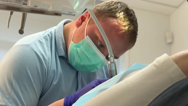 Complete dental filling procedure with patient dentist microscope anesthesia rubber dam and modern restorative treatment set. professional dental care.