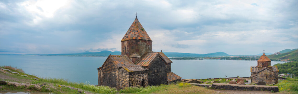 Sevanavank monastery panorama with twin stone churches and lake Sevan copy space