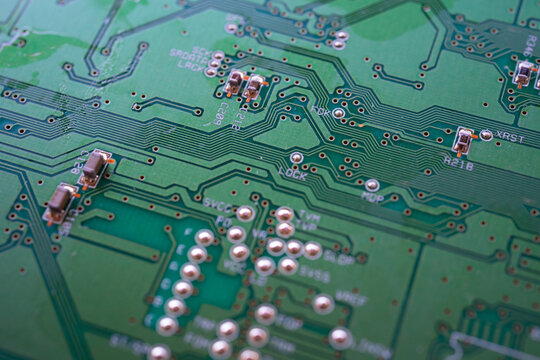 Macro shot of a printed circuit board with electronic traces and precision components