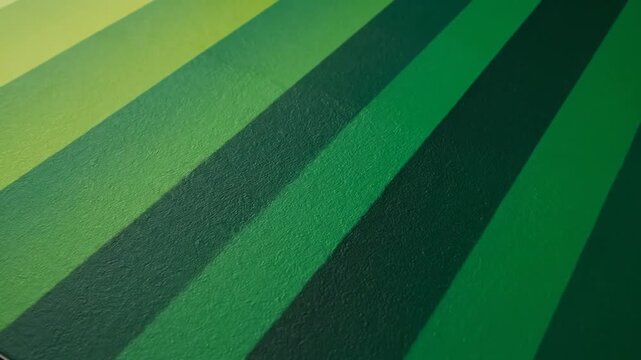 Abstract background consisting of diagonal parallel stripes in varying shades of green, transitioning from deep emerald to vibrant lime with a fine textured matte surface.