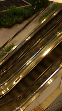 Editorial July 06 2026 &mdash; Shoppers and Commuters Riding Escalator Up to BTS Skytrain Skywalk Station, EmQuartier Shopping Mall Bangkok Thailand
