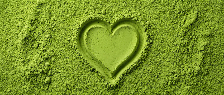 Embossed Heart Shape in Matcha Powder Background, Premium Green Tea Texture with Copy Space