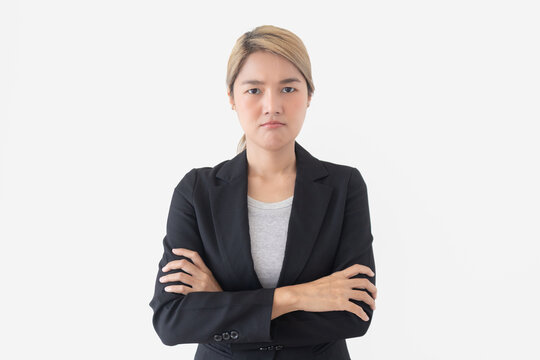 Serious Young Thai Asian Businesswoman with Crossed Arms Looking Sternly at Camera on White Background