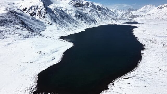 Frozen Alpine Lake Surrounded by Snow Covered Mountain Peak Landscape in Winter at Arabel Plateau