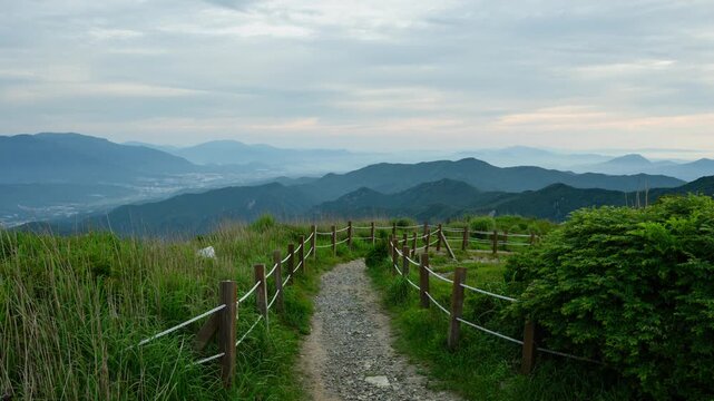 Mountain Trail with Mountain Range View on Cloudy Day Timelapse with Zoom Out