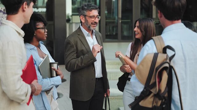 University students talking to professor after classes, giving advice and education support