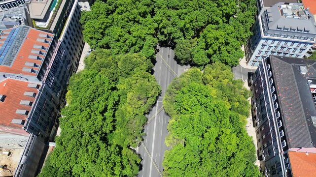 Aerial view from Av da Liberdade revealing Lisbon city ,Portugal. Backwards drone shot
