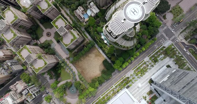 Top down aerial view of Taipei, the vibrant capital city of Taiwan, showing streets, parks and modern skyscrapers in the Xinyi District on a sunny day.