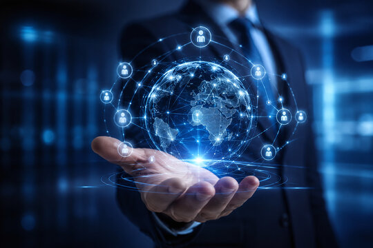 Businessman holding digital globe with connected people icons. Global recruitment, international HR management, and worldwide networking concept in futuristic digital background.