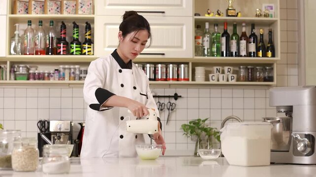 Master pastry chef whipping raw egg whites with sprinkles sugar with butter in white bowl with electric mixer beat for delicious birthday bakery order, ideal for baking confectionery, culinary concept