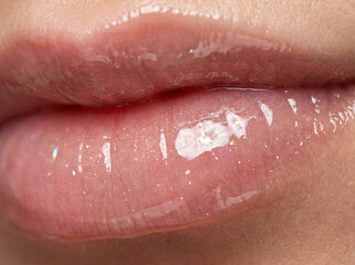 Fototapeta premium Glossy lips macro closeup with shimmering shine and soft texture, showcasing beauty and allure
