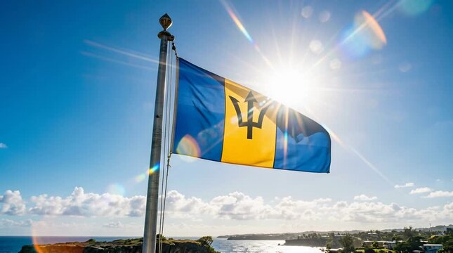 Barbados flag waving on a pole against a bright sunny sky with lens flare, national pride and travel imagery
